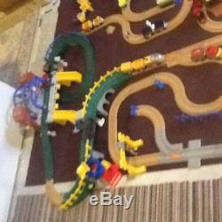 Geotrax train set with tracks, bridges, buildings, engines, cars, and remote