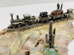 Vintage miniature pewter train set with track diorama on rock