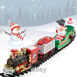 Ensemble de train électrique de Noël avec piste autour de l'arbre, musique, lumière et Père Noël